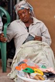 20: Saleswoman resting in Makola market, Accra.